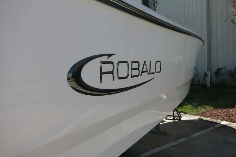 Slide: The Image of 2025 Robalo R250 Center Console boat side view with logo. - 12