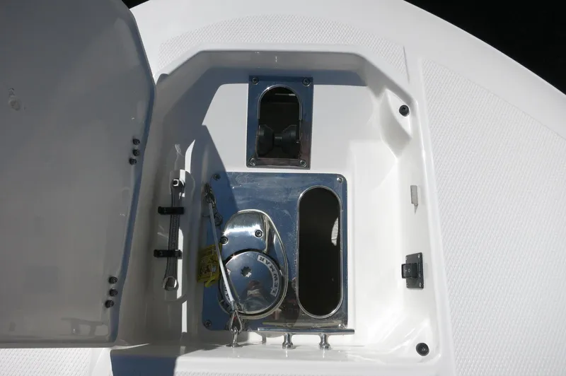Slide: The Image of 2025 Robalo R250 Center Console anchor storage compartment with open hatch. - 16