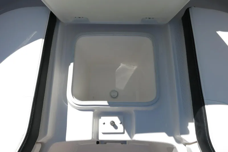 Slide: The Image of 2025 Robalo R250 Center Console boat storage compartment, open and empty. - 17