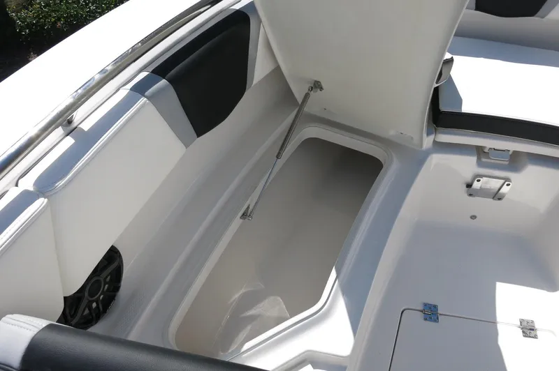 Slide: The Image of 2025 Robalo R250 Center Console boat storage compartment with open lid and sleek design. - 18