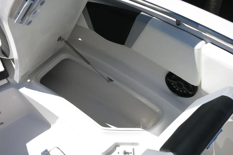 Slide: The Image of 2025 Robalo R250 Center Console boat storage compartment with open lid. - 19