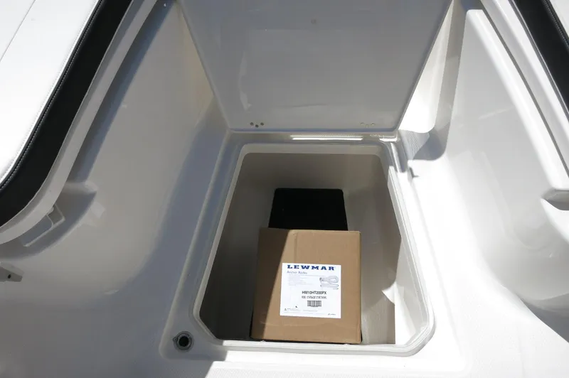 Slide: The Image of 2025 Robalo R250 Center Console storage compartment with Lewmar box inside. - 21