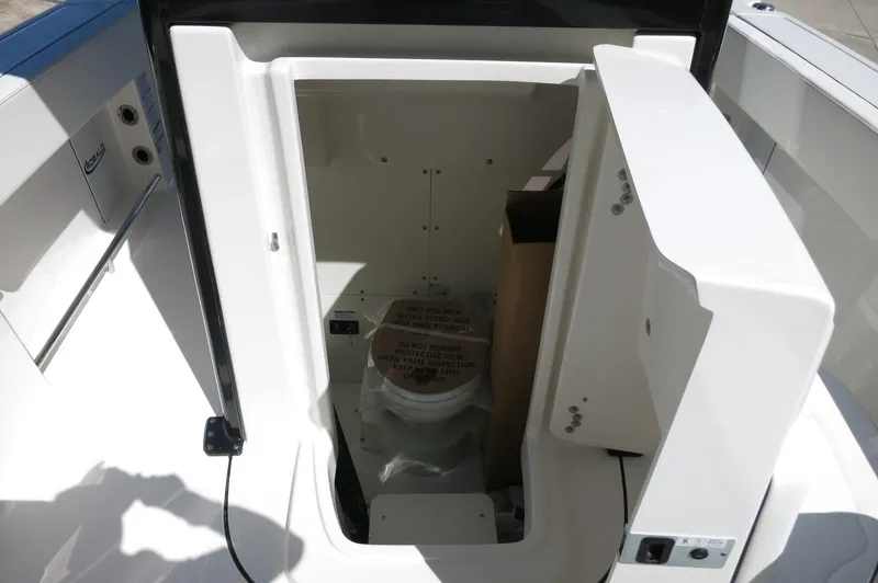 Slide: The Image of 2025 Robalo R250 Center Console boat interior with open storage compartment. - 24
