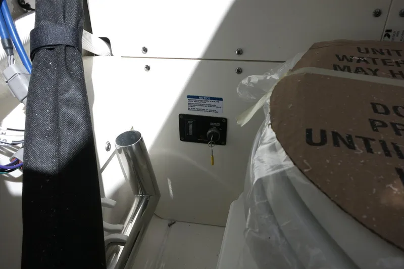 Slide: The Image of Interior view of a 2025 Robalo R250 Center Console boat, featuring equipment and storage area. - 25