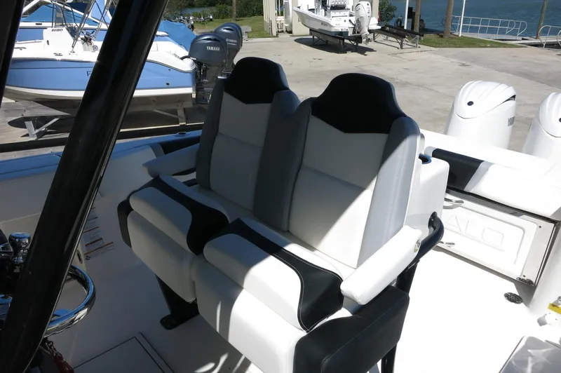 Slide: The Image of 2025 Robalo R250 Center Console boat with dual seats, docked near water. - 32