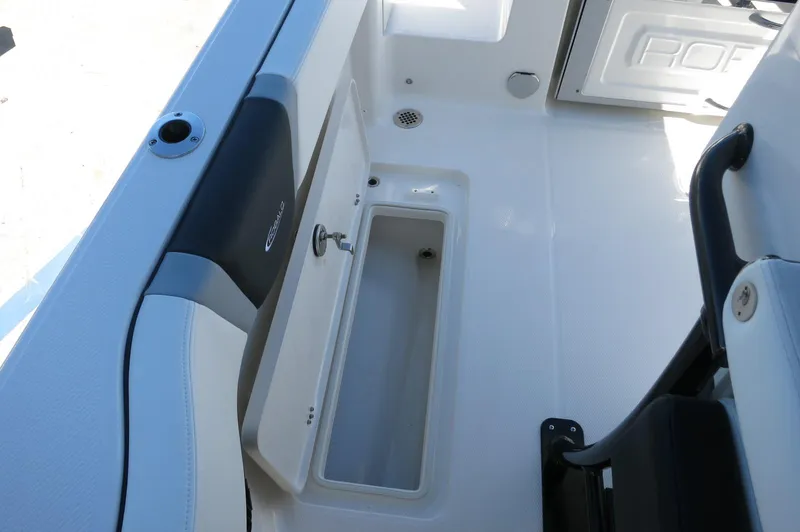 Slide: The Image of 2025 Robalo R250 Center Console boat interior with storage compartment and seating. - 38