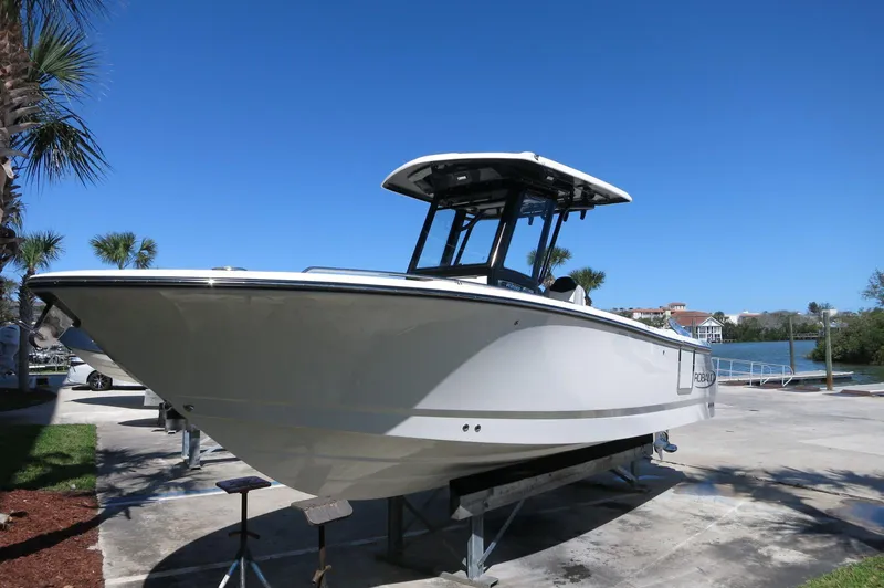 Slide: The Image of 2025 Robalo R250 Center Console boat on display under clear blue sky. - 4