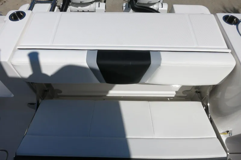Slide: The Image of 2025 Robalo R250 Center Console boat seating area with white cushioned seats. - 40
