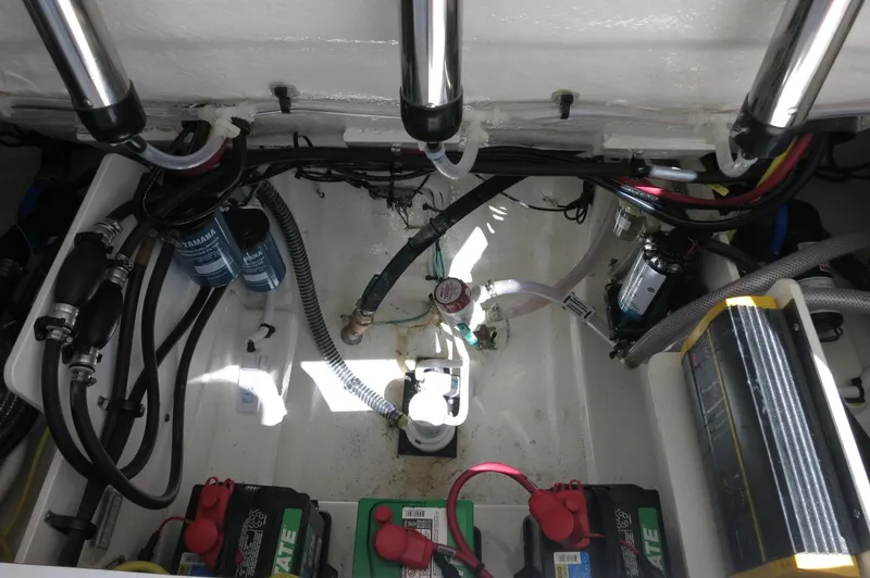 Slide: The Image of Engine compartment of 2025 Robalo R250 Center Console boat, showing batteries and wiring. - 42