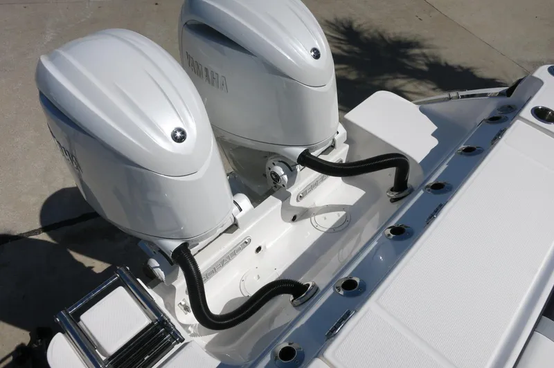 Slide: The Image of 2025 Robalo R250 Center Console with dual outboard engines, rear view. - 48