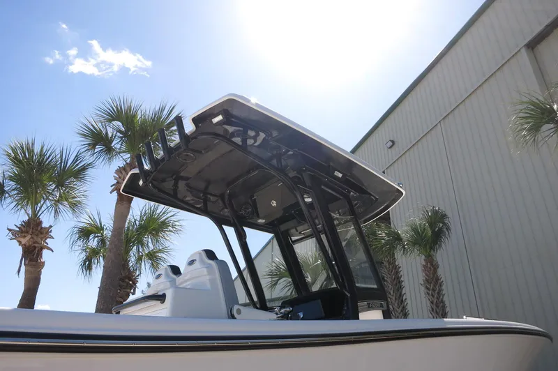 Slide: The Image of 2025 Robalo R250 Center Console boat under sunny sky with palm trees. - 49