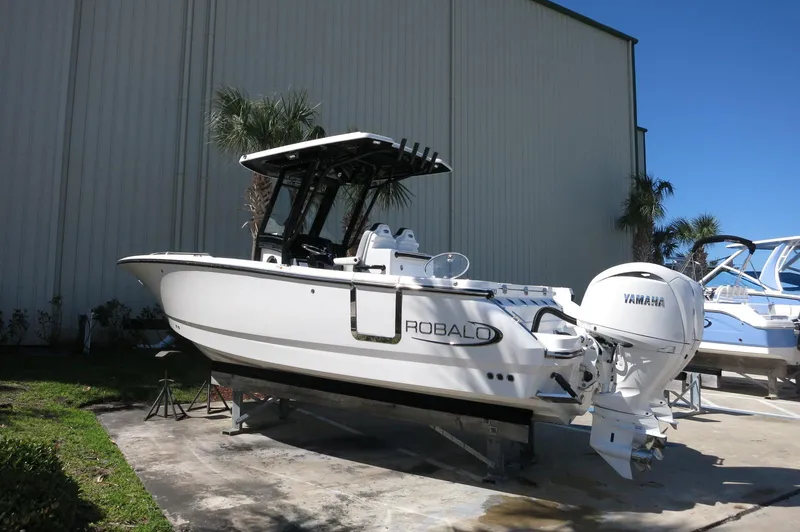 Slide: The Image of 2025 Robalo R250 Center Console boat with Yamaha engine, parked outdoors. - 5