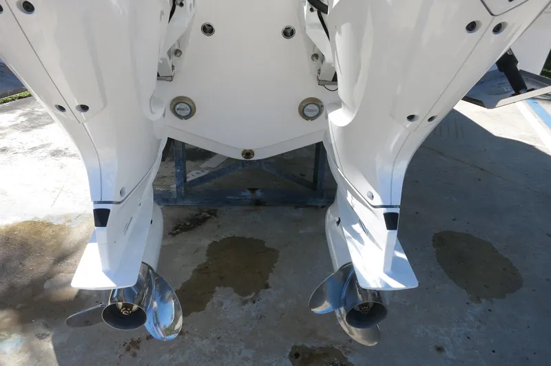 Slide: The Image of 2025 Robalo R250 Center Console boat with dual outboard motors. - 8