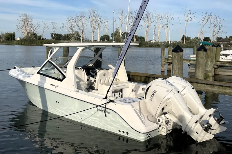 Slide: The Image of 2025 Edgewater 262 CX boat docked with dual Yamaha engines. - 0