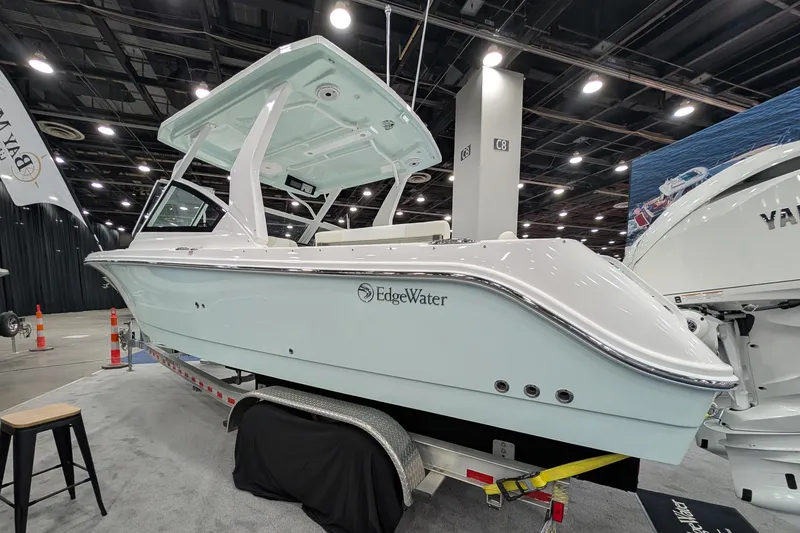 Slide: The Image of 2025 Edgewater 262 CX boat displayed indoors on a trailer. - 12