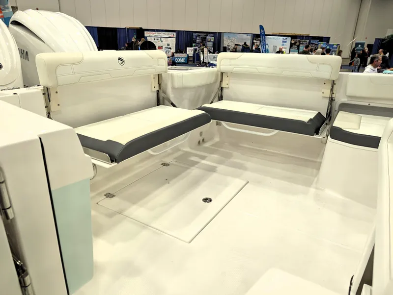 Slide: The Image of 2025 Edgewater 262 CX boat interior with white seating and modern design. - 2