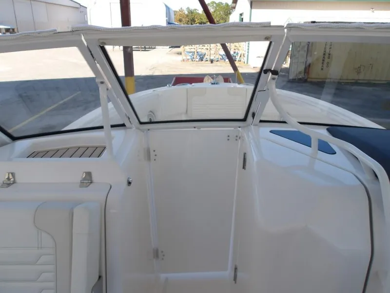Slide: The Image of 2025 Edgewater 262 CX boat interior with open windshield and seating area. - 26
