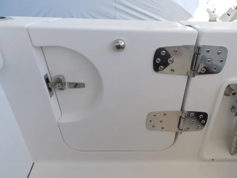 Slide: The Image of 2025 Edgewater 262 CX boat compartment with stainless steel hinges and latch. - 32