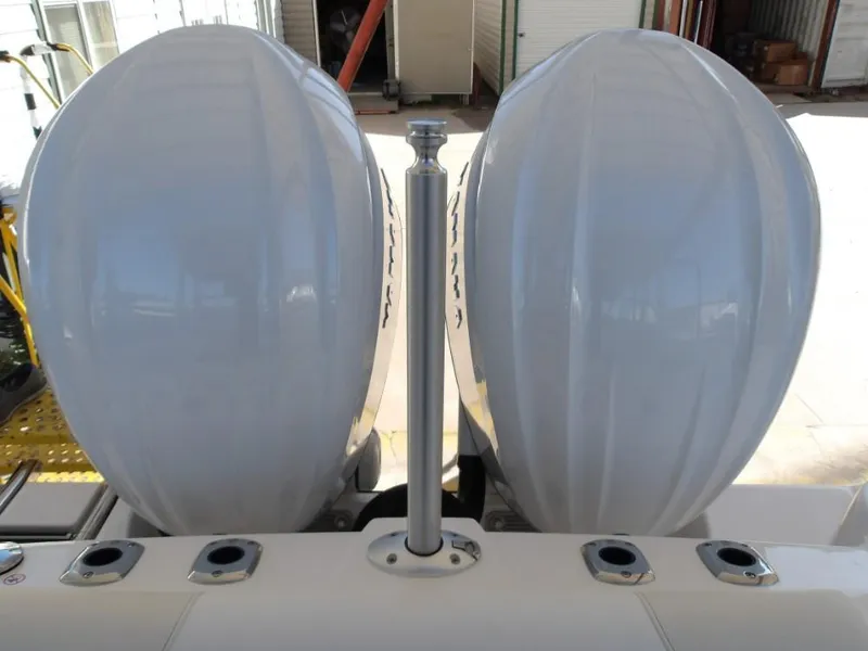 Slide: The Image of 2025 Edgewater 262 CX boat with dual outboard motors in a storage facility. - 37
