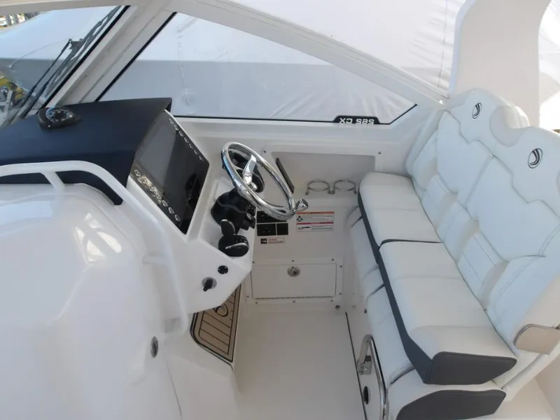 Slide: The Image of 2025 Edgewater 262 CX boat interior with steering wheel and cushioned seating. - 4