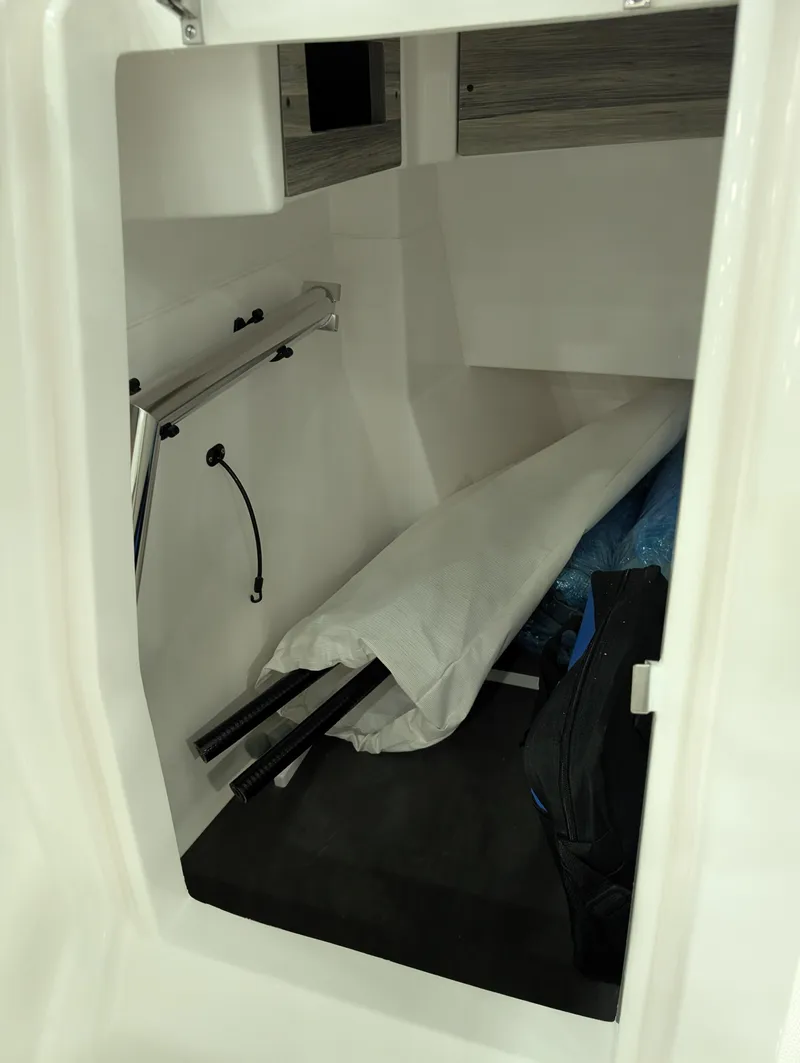 Slide: The Image of 2025 Edgewater 262 CX cabin interior with storage and equipment. - 42