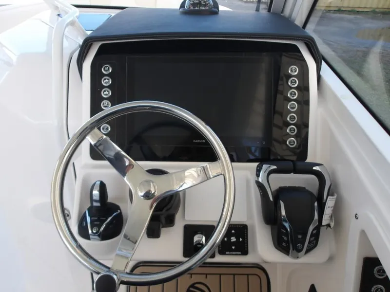 Slide: The Image of Helm of 2025 Edgewater 262 CX boat with modern steering and controls. - 5