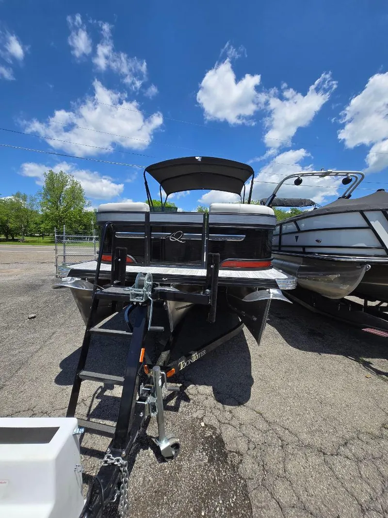Slide: The Image of 2025 Quest 22rls boat on trailer under blue sky with clouds. - 1