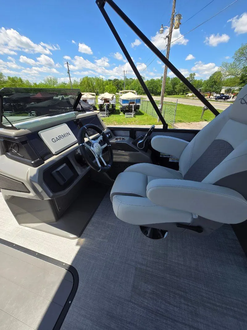 Slide: The Image of 2025 Quest 22rls boat interior with Garmin navigation, steering wheel, and captain's chair. - 10