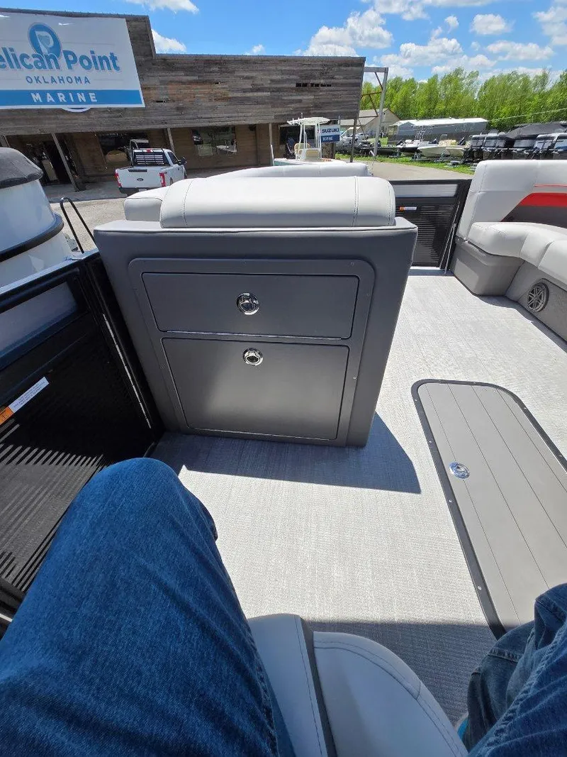 Slide: The Image of 2025 Quest 22rls boat interior with seating and storage, at Pelican Point Marina. - 11