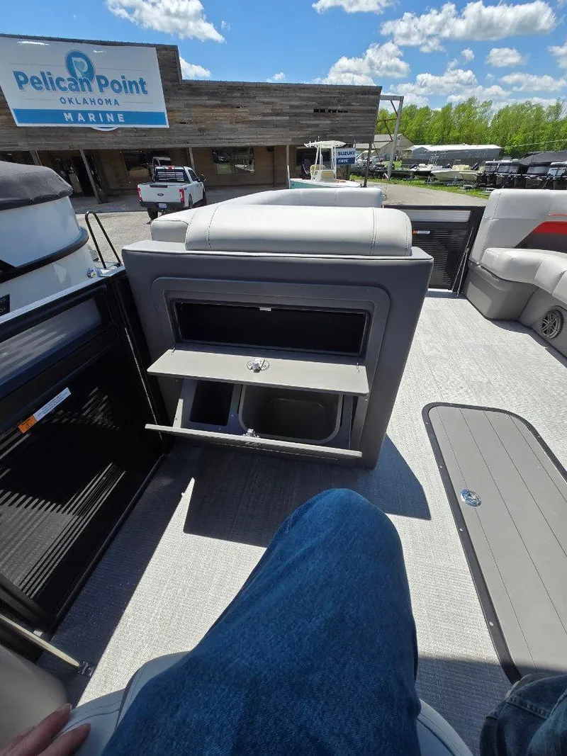 Slide: The Image of 2025 Quest 22rls boat interior at Pelican Point Marina, showcasing seating and storage. - 12