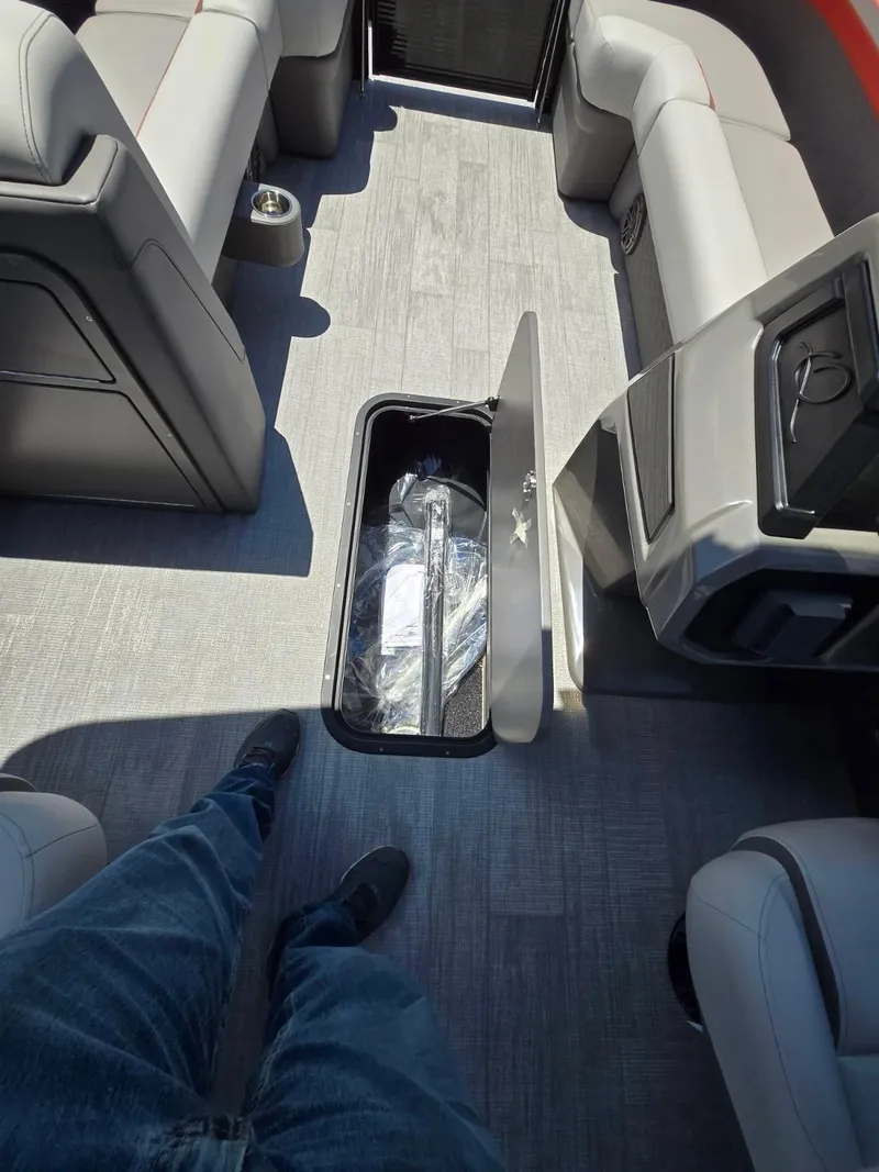 Slide: The Image of 2025 Quest 22rls interior with open floor storage compartment and seating. - 14