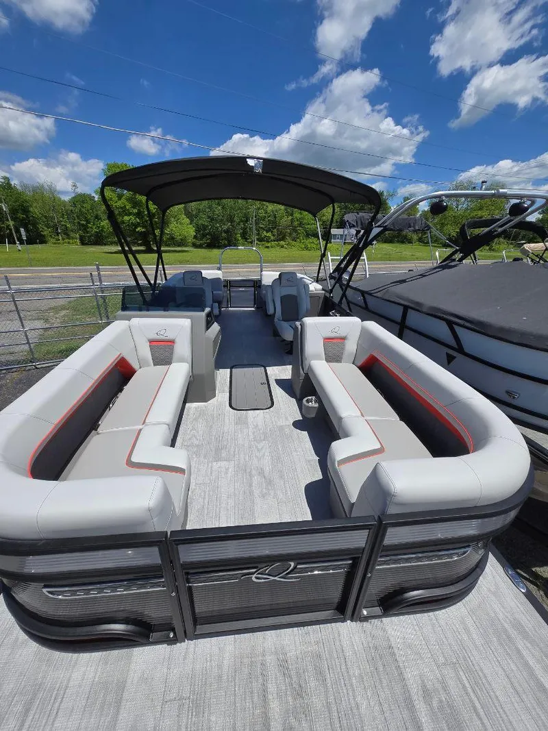 Slide: The Image of 2025 Quest 22rls pontoon boat with spacious seating and canopy under a clear blue sky. - 3