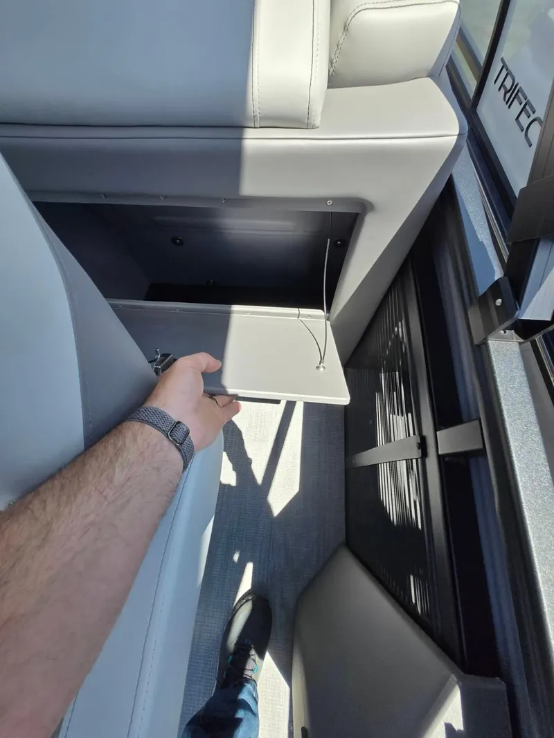 Slide: The Image of 2025 Quest 22rls interior storage compartment with open lid, showcasing modern design and functionality. - 6