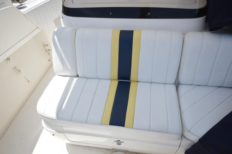 Slide: The Image of White boat seat with yellow and blue stripes, Intrepid 323 Cuddy, 2004 model. - 16