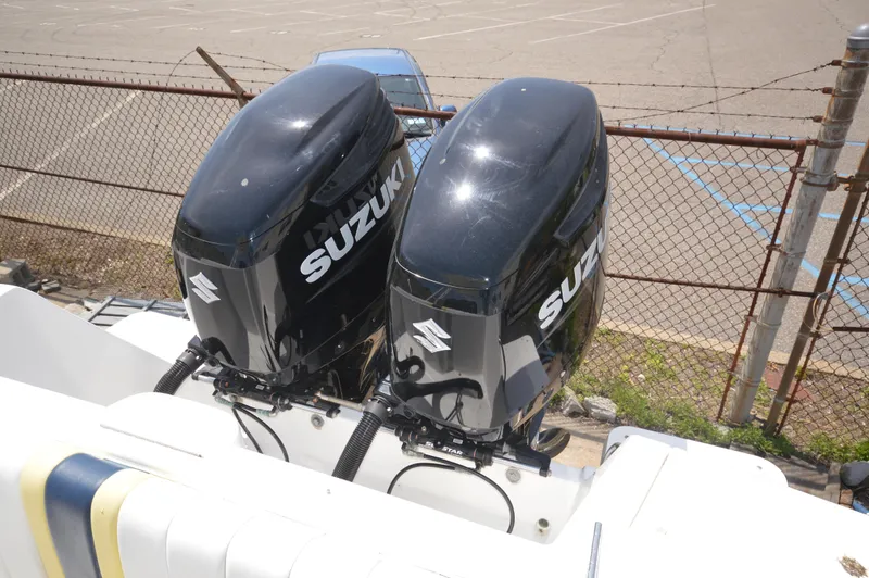Slide: The Image of Twin Suzuki outboard motors on a 2004 Intrepid 323 Cuddy boat. - 20
