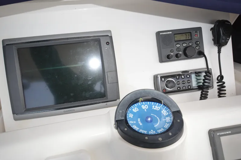 Slide: The Image of Dashboard of a 2004 Intrepid 323 Cuddy with navigation and communication equipment. - 24