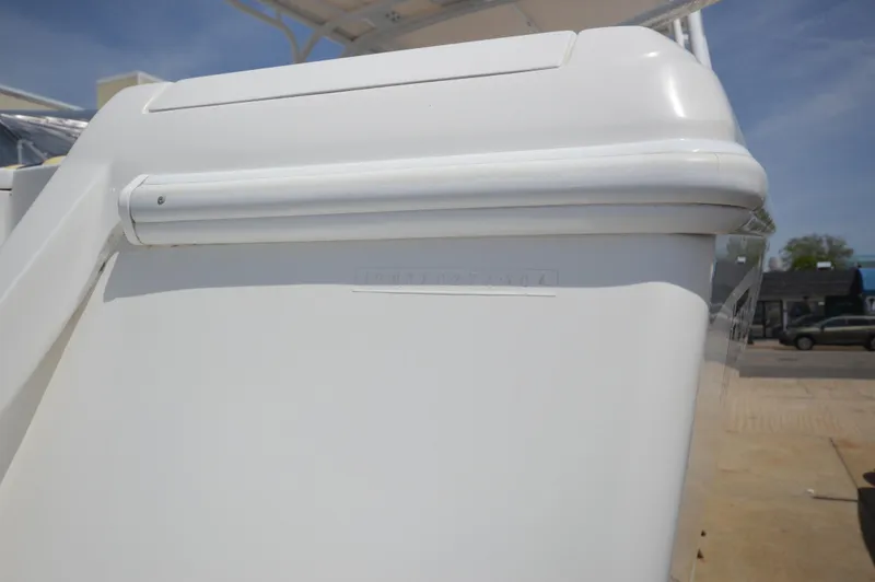 Slide: The Image of 2004 Intrepid 323 Cuddy boat, white exterior, docked on a sunny day. - 7