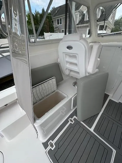 Slide: The Image of 2022 NorthCoast 255 Cabin interior with seating and storage compartments. - 10