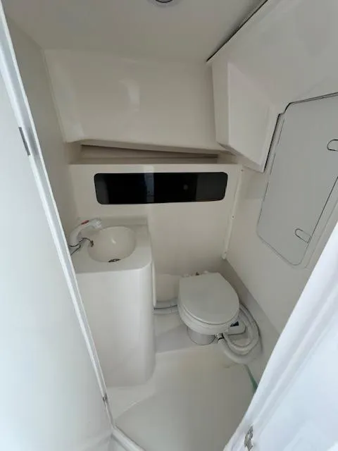 Slide: The Image of 2022 NorthCoast 255 Cabin bathroom with compact toilet and sink. - 15