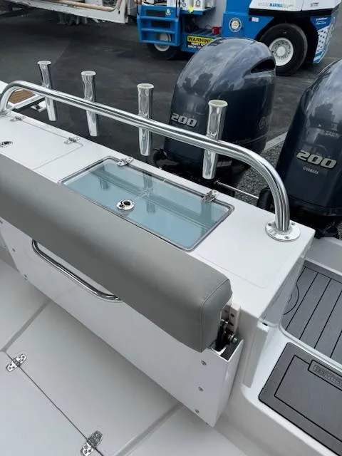 Slide: The Image of 2022 NorthCoast 255 Cabin boat with dual 200 horsepower engines and fishing rod holders. - 5
