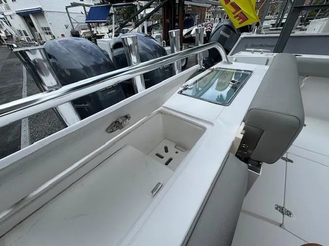 Slide: The Image of 2022 NorthCoast 255 Cabin boat interior with storage compartments and seating. - 8