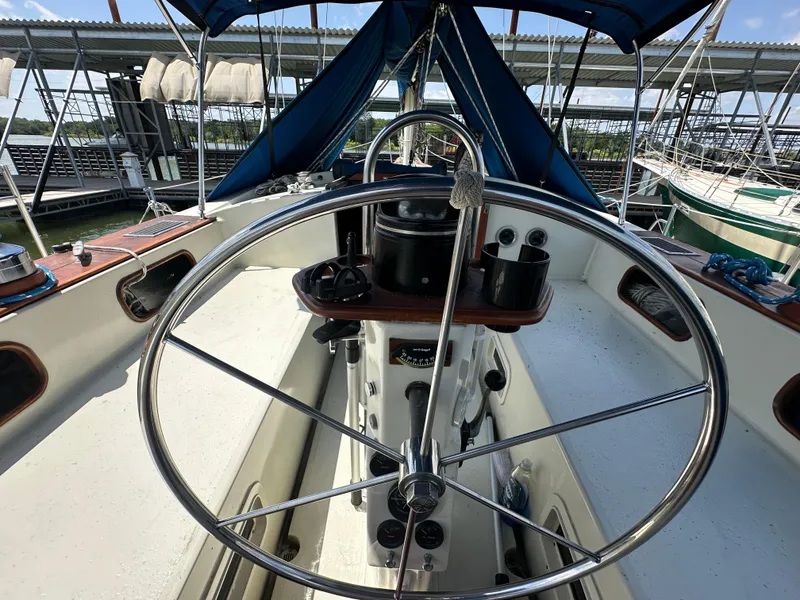 Slide: The Image of Cockpit of 1982 Irwin 46 sailboat with steering wheel and navigation instruments. - 12