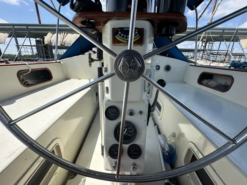 Slide: The Image of Cockpit view of 1982 Irwin 46 sailboat with steering wheel and gauges. - 13