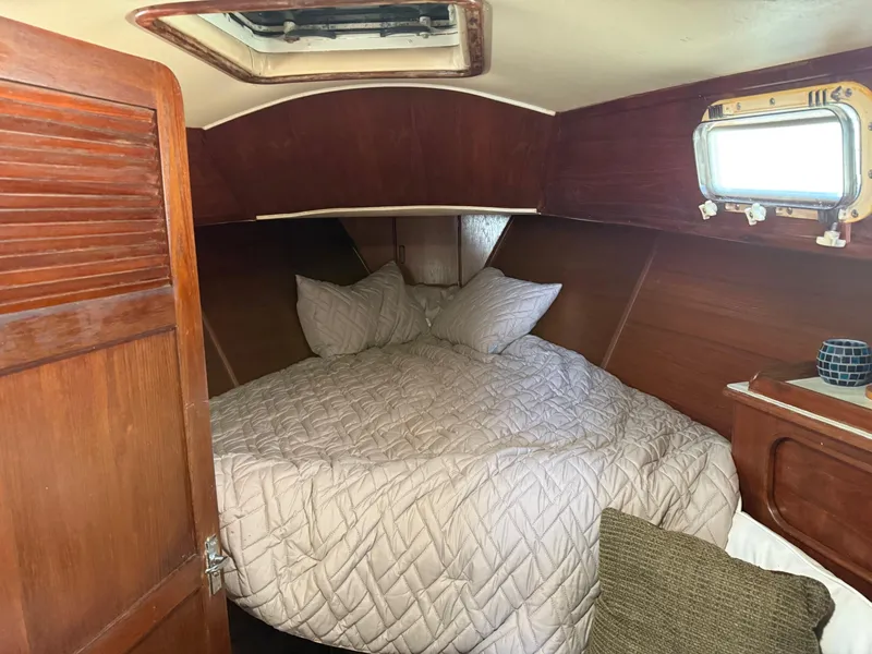 Slide: The Image of Cozy cabin interior of 1982 Irwin 46 sailboat with bed and wooden paneling. - 19