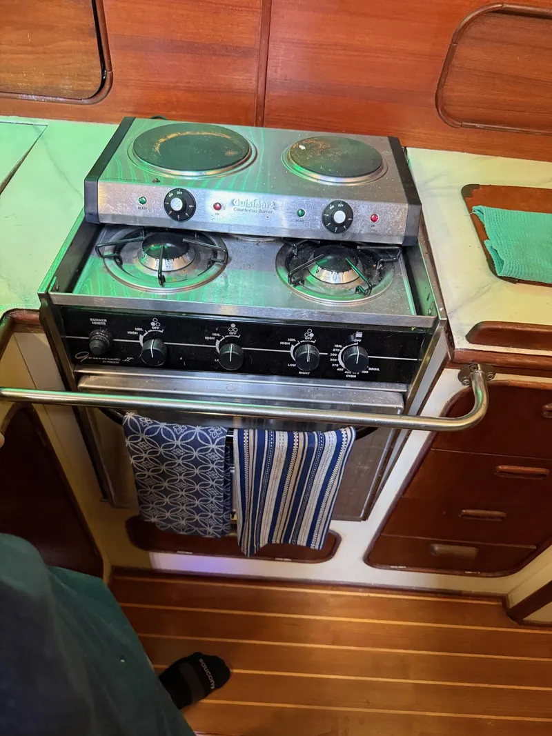 Slide: The Image of 1982 Irwin 46 yacht kitchen with stove, oven, and towels. - 27