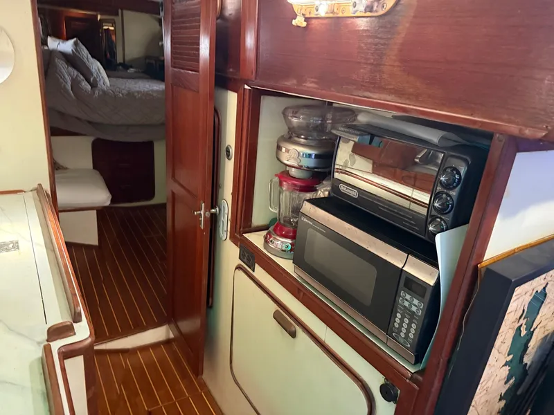 Slide: The Image of Interior of 1982 Irwin 46 sailboat with kitchen appliances and cozy cabin. - 28