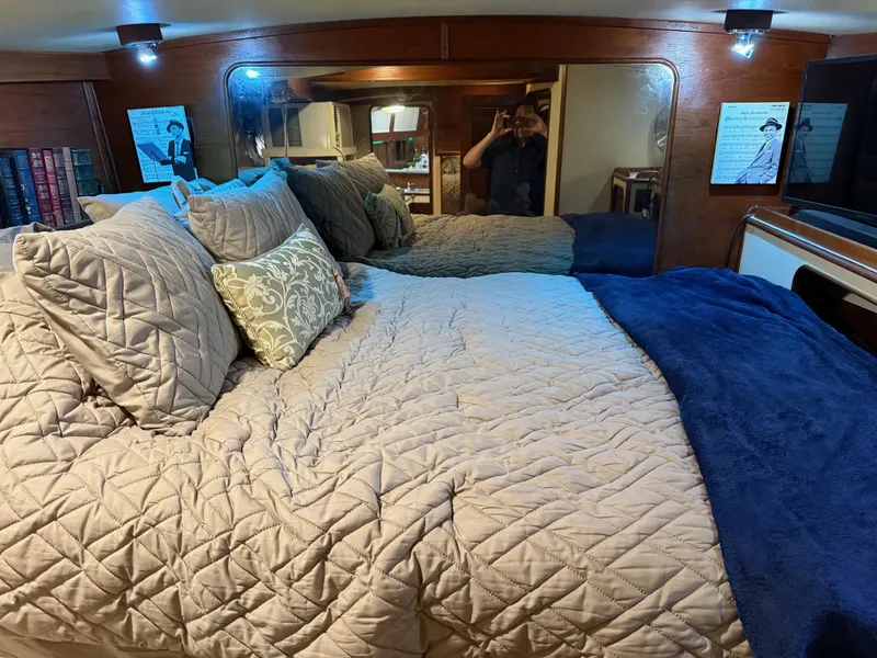 Slide: The Image of Cozy bedroom in 1982 Irwin 46 yacht with plush bedding and ambient lighting. - 30