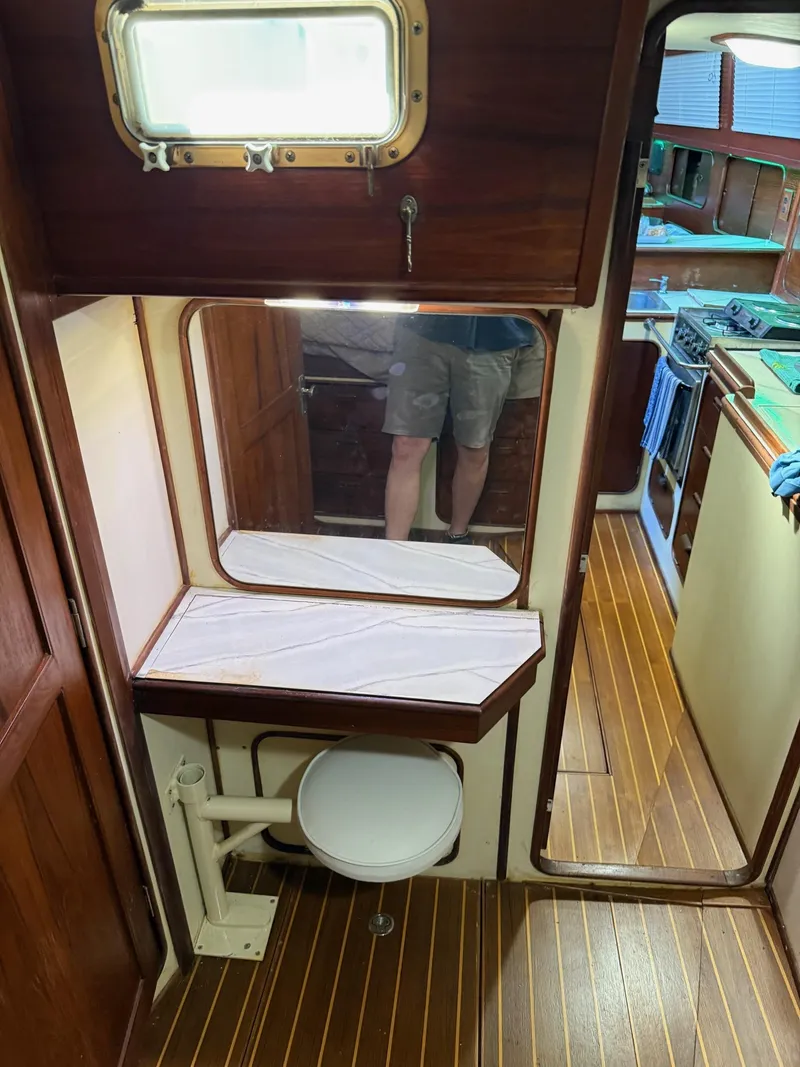 Slide: The Image of Interior of 1982 Irwin 46 sailboat with wooden flooring and compact bathroom. - 34