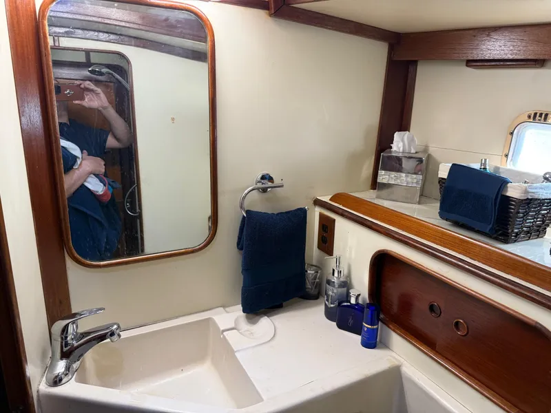 Slide: The Image of Bathroom interior of 1982 Irwin 46 yacht with sink, mirror, and toiletries. - 38