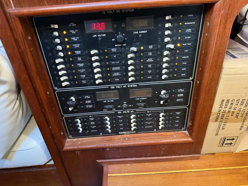 Slide: The Image of Electrical control panel on a 1982 Irwin 46 sailboat, featuring 12V and 120V systems. - 39